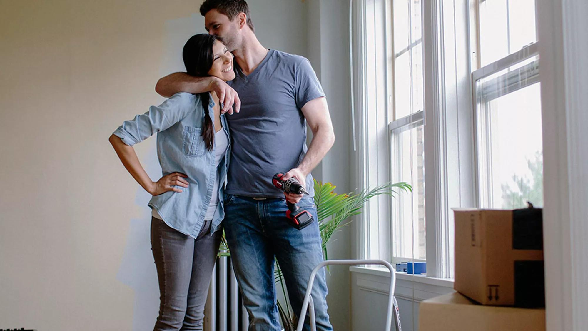 Photo of a couple budgeting for a home.